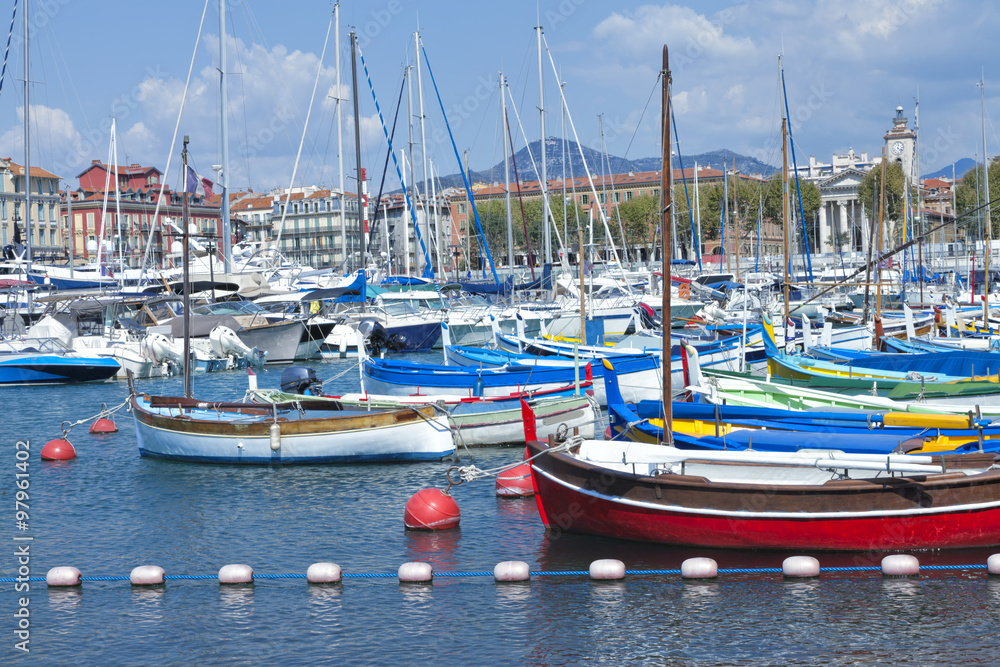 Fishing boats, super yachts in sea marina in Nice Port French Riviera on sunny summer day