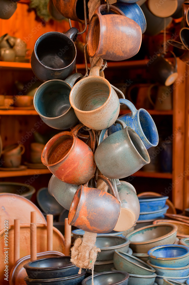 Bunch of hanging ceramic mugs in a street market in Marburg, Germany Bunch of hanging ceramic mugs in a street market in Marburg, Germany