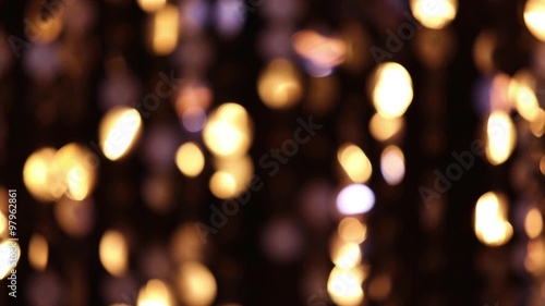Abstract glittering lights, gold background, a real shot video in the blur