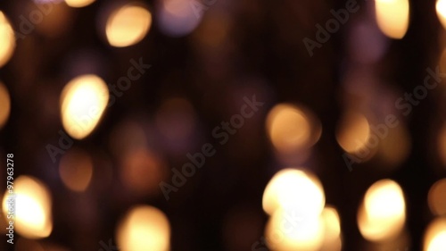 Abstract glittering lights, gold background, a real shot video in the blur