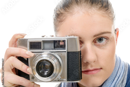 Young photographer woman with a vintage camera