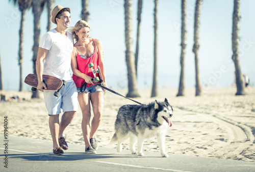 Young couple with husky dog in Santa monica