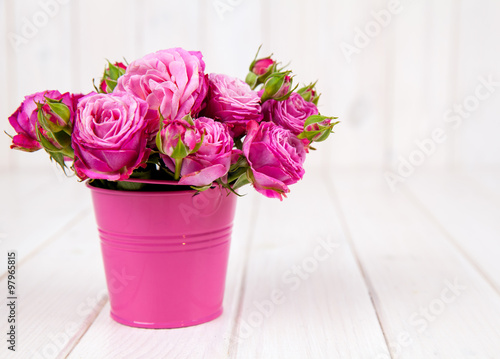 Pink roses(peony) in vase on white wooden background. flowers
