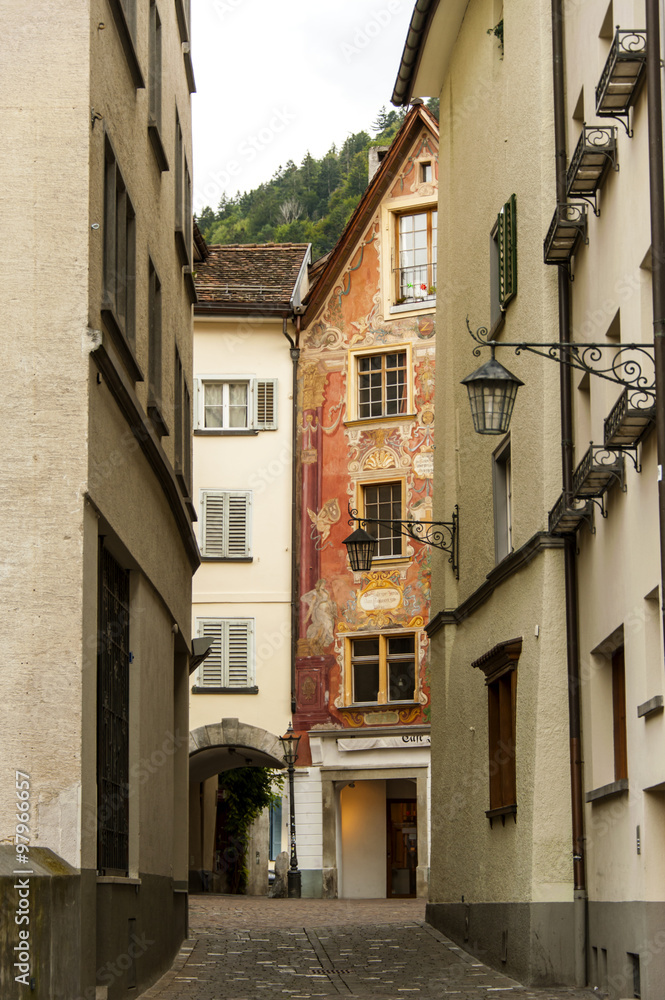 a narrow historic street in the old part of of city of Chur.