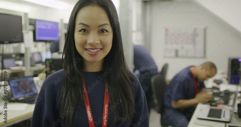 Portrait of cheerful female worker in an electronics factory Portrait of cheerful female worker in an electronics factory