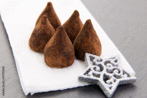 chocolate truffles on napkin with Christmas background