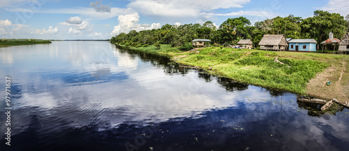Reflection of the cloud on a black water tributary river of the Amazon.
