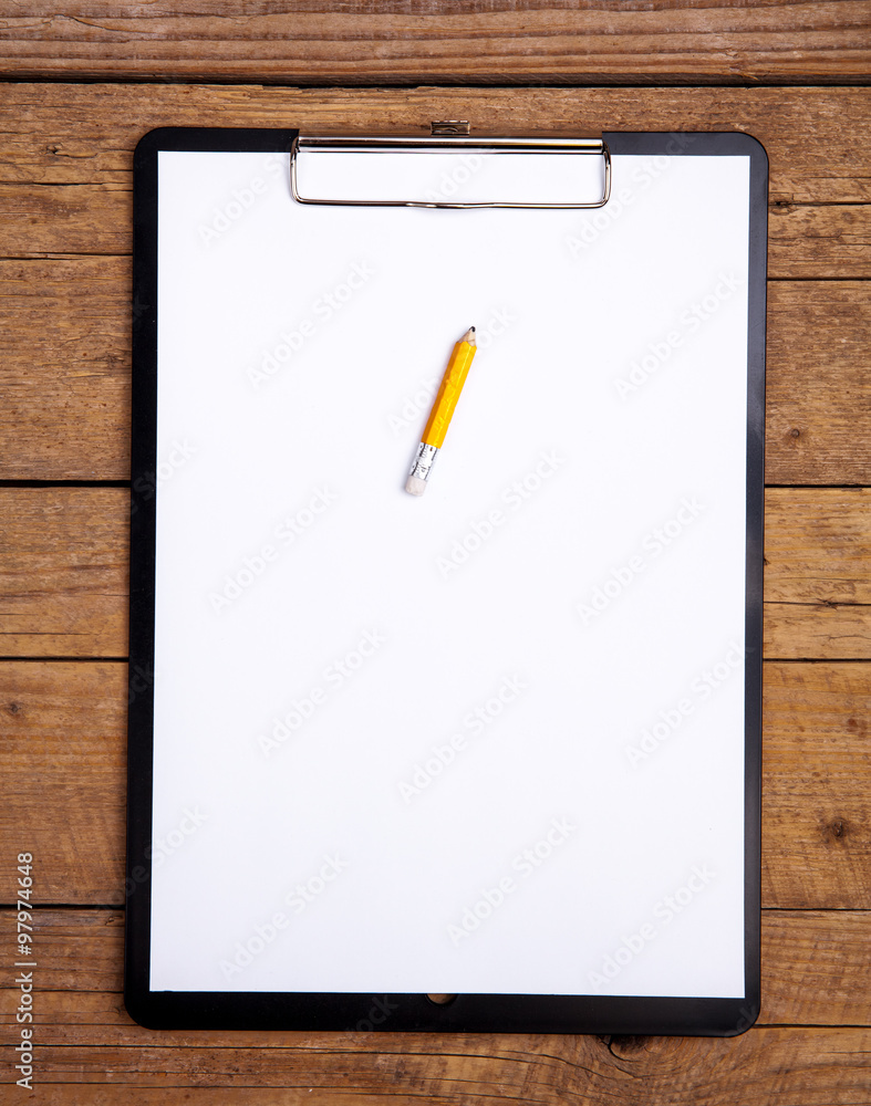 blank paper in clipboard on wooden table blank paper in clipboard on wooden table