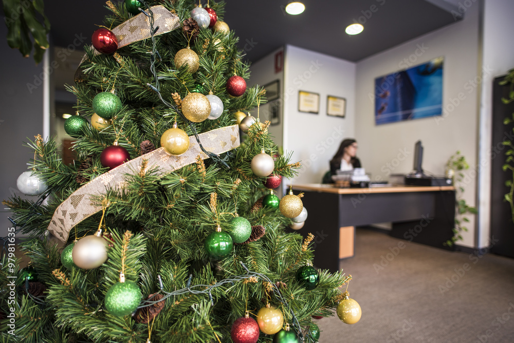 Decorated Christmas tree in office. Woman on background Stock Photo | Adobe  Stock