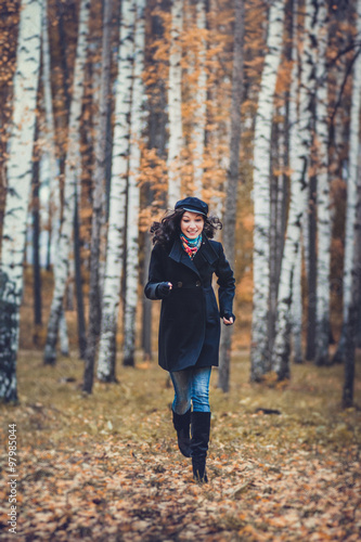 Fashion woman running in autumn park © EdNurg