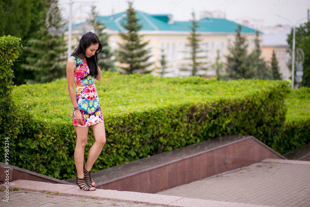 Naklejka premium Beautiful young woman in color dress
