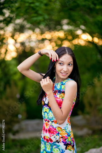 Beautiful young woman in color dress