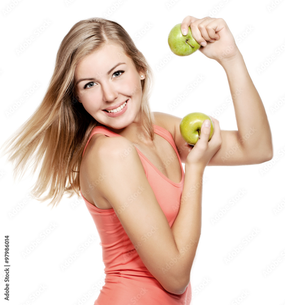 young blond woman with an apple looking towards camera isolated over white young blond woman with an apple looking towards camera isolated over white