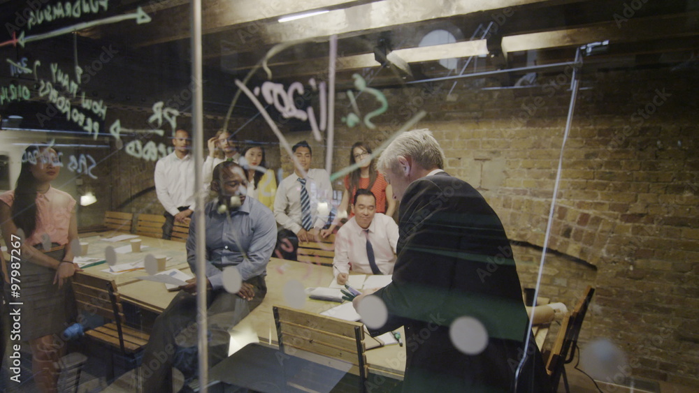 Diverse business team brainstorming in a meeting in modern glass office Diverse business team brainstorming in a meeting in modern glass office