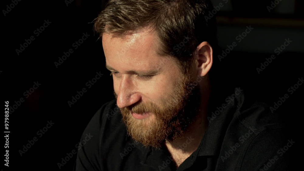 Man with ginger beard looking around and smiling
Man with ginger beard looking around and smiling