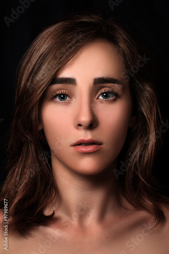 Wallpaper Mural Close Up dramatic portrait of a young girl on a dark background. low key. dark art Torontodigital.ca