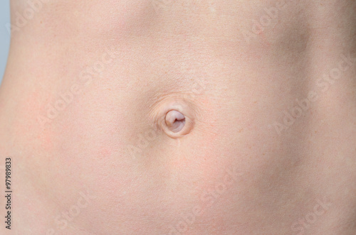 Flat Belly of a Bare middle-aged Woman in Close up photo