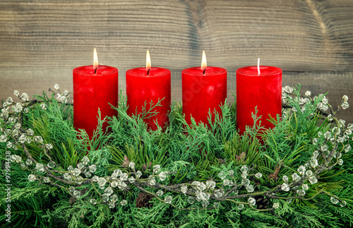Advent decoration with three red burning candles
