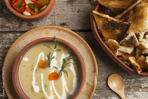 Fresh cream soup in a bowl with bread and seasonal salad