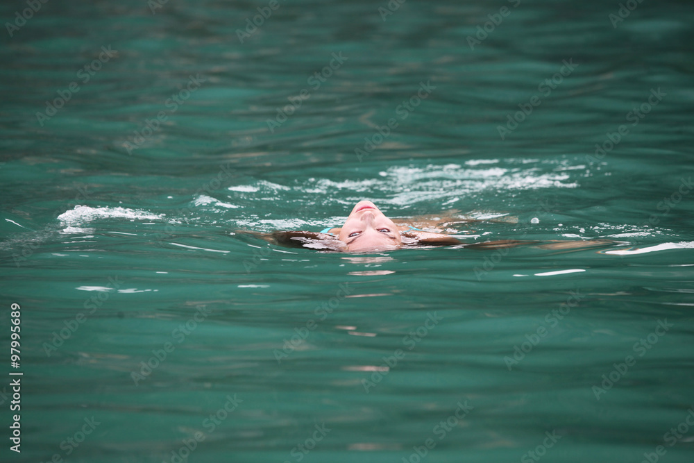 Woman floating in sea