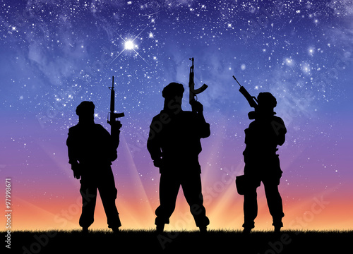 Silhouette of men standing against starry sky at night