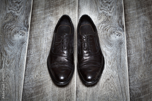 Classic black men's shoes on a wooden background