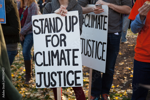 Stand up for climate justice two signs photo
