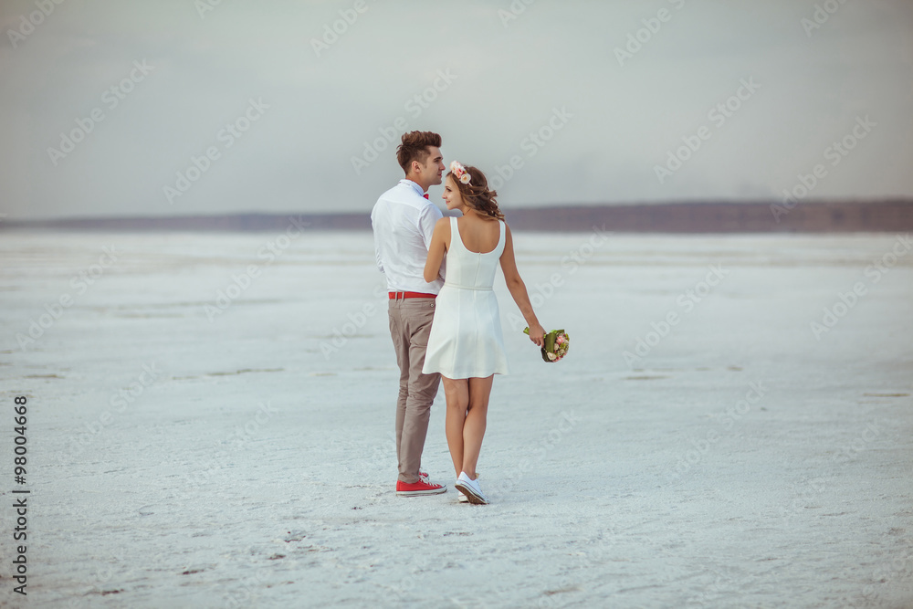 Fototapeta premium Couple walking on beach. Wedding