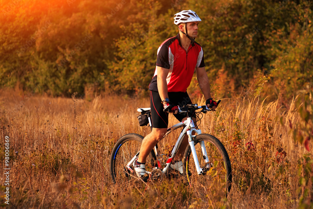 Biker on the forest road riding outdoor Biker on the forest road riding outdoor