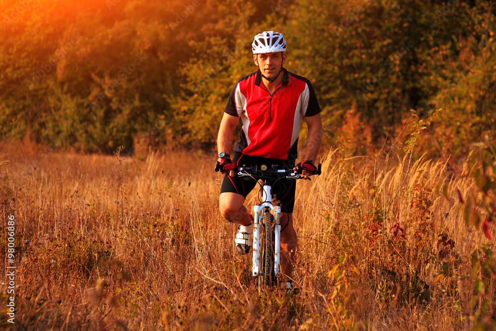Biker on the forest road riding outdoor Biker on the forest road riding outdoor