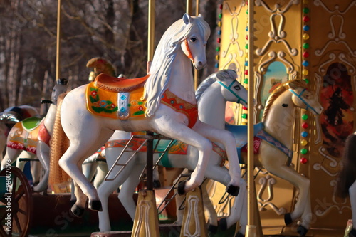 Carousel with horses in City Park in morning sun