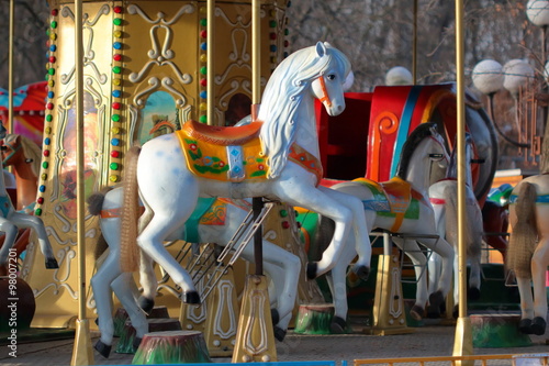 Carousel with horses in City Park in morning sun