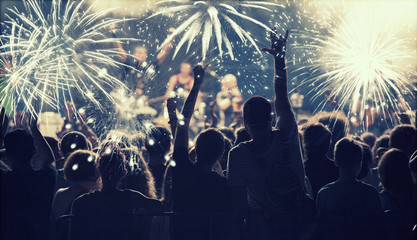 New Year concept - cheering crowd and fireworks