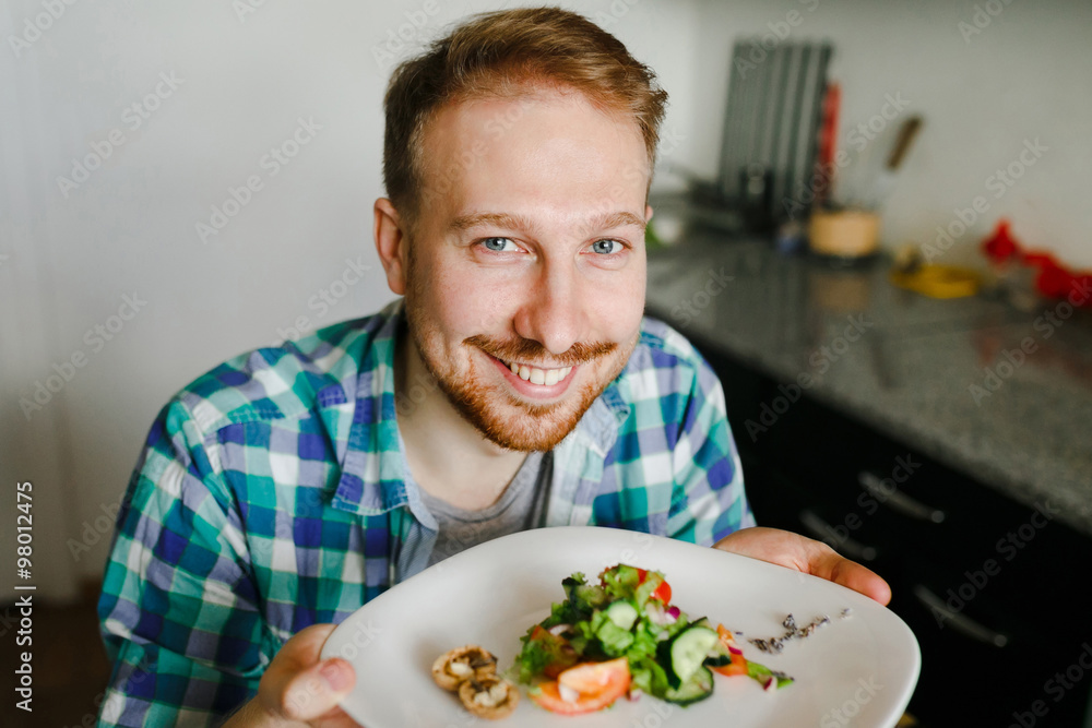 Young man cooking in home kitchen Young man cooking in home kitchen