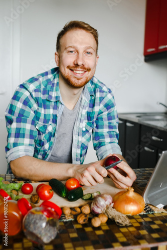 Young man cooking in home kitchen