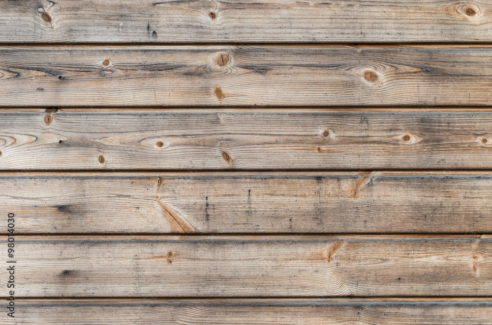 Weathered larch wooden planks on the building facade with blue stain and mold Weathered larch wooden planks on the building facade with blue stain and mold