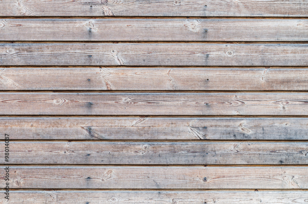 Weathered larch wooden planks on the building facade with blue stain and mold Weathered larch wooden planks on the building facade with blue stain and mold