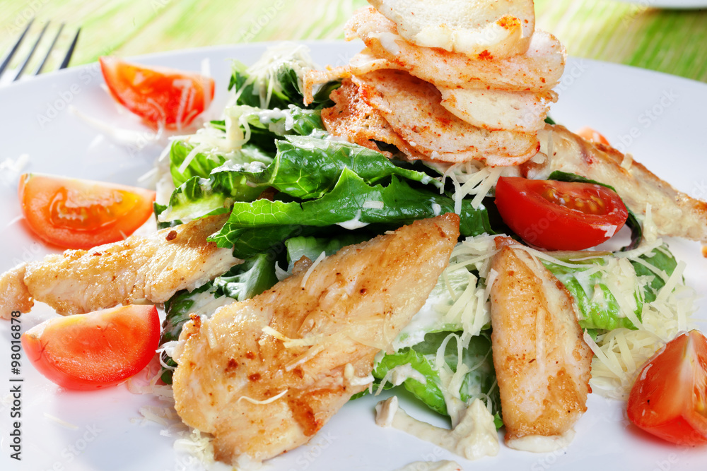 Caesar salad in a still life with chicken and croutons close-up for the menu Caesar salad in a still life with chicken and croutons close-up for the menu