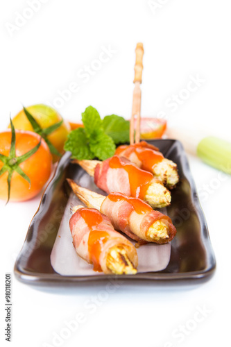 grilled meat with corn on black plate on white background