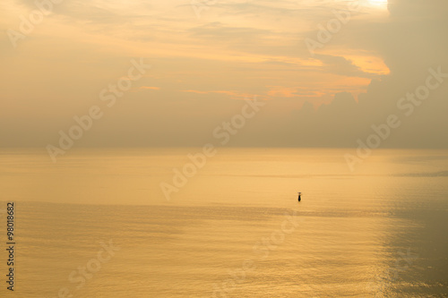 sunset of flashing buoy floating on calm sea © Prathaan