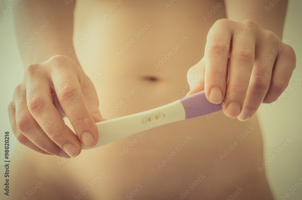 Pregnant woman holding positive pregnancy test Pregnant woman holding positive pregnancy test