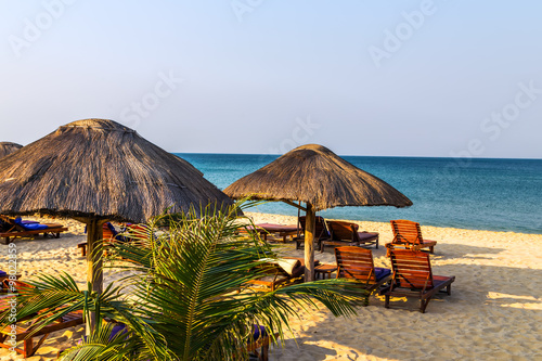 beach lounge chairs under tent on beach