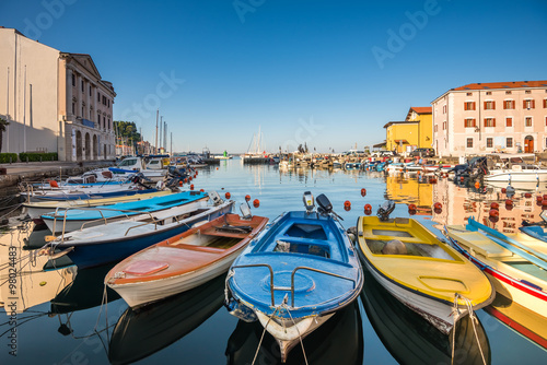 View of the Venetian Port of Piran, Slovenia with Boats in Foreground and Clear Blue Sky
