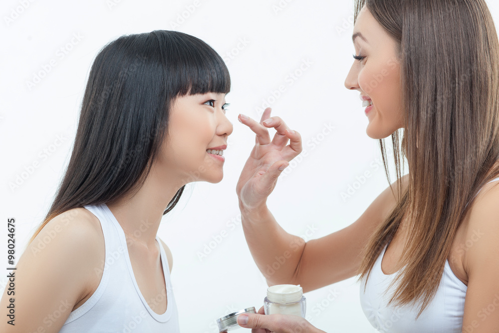 Attractive two female friends are caring of skin Attractive two female friends are caring of skin
