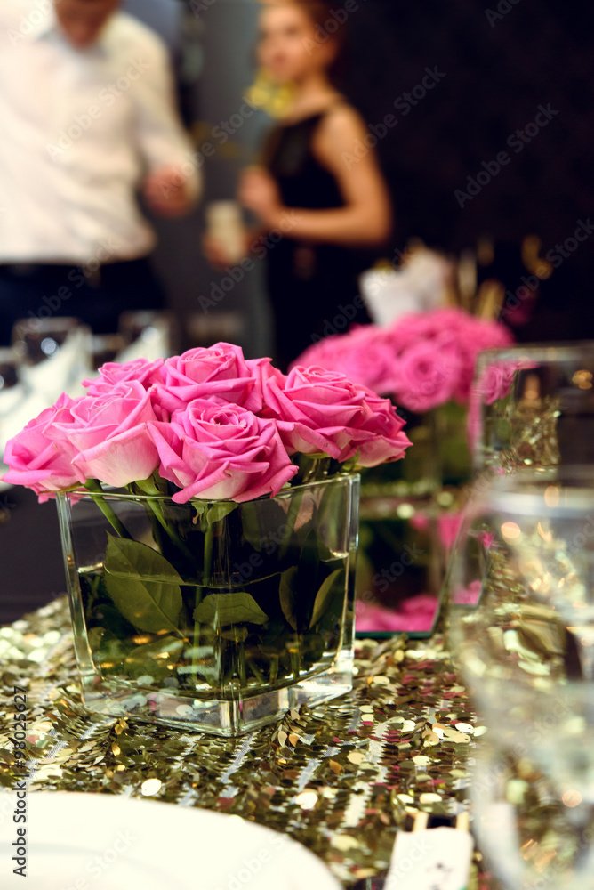 stylish luxury decorated tables with roses at the golden birthda