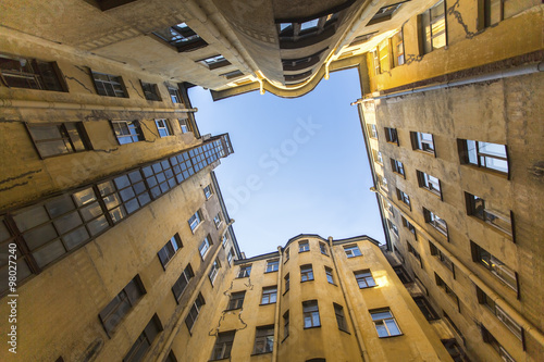 Bottom view on a typical courtyard-a well in the old district of St. Petersburg in Russia.