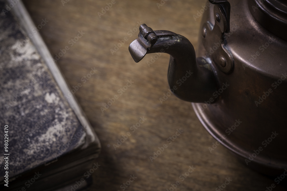 old kettle on a grunge wooden surface old kettle on a grunge wooden surface