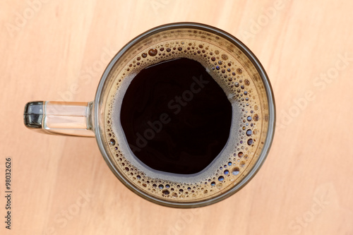 Top view of an cup of coffee with some bubbles.