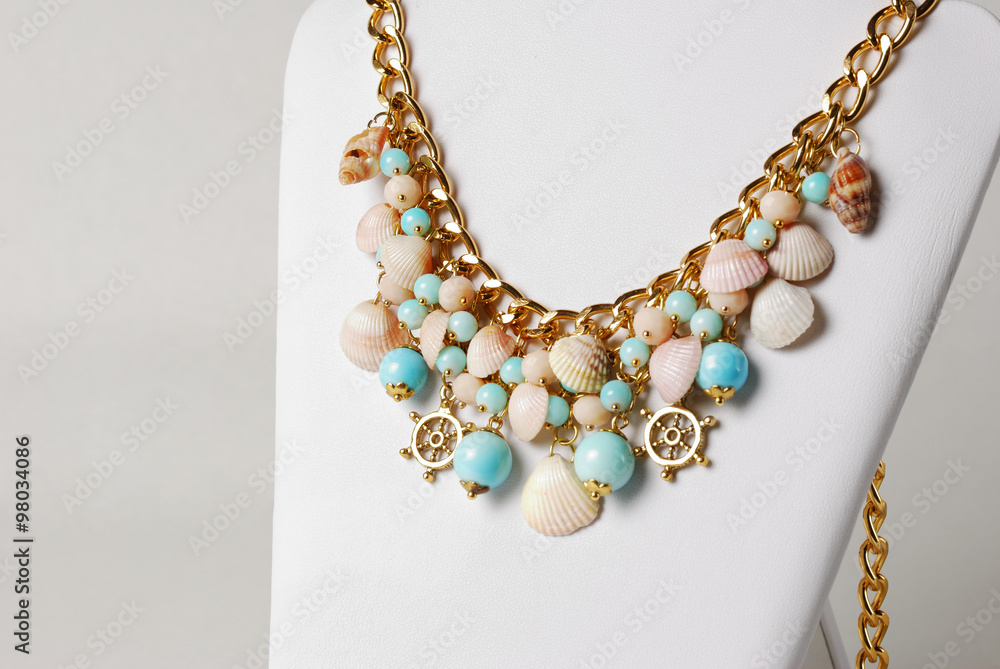 Beautiful necklace in marine style with seashells, and little wheels Beautiful necklace in marine style with seashells, and little wheels