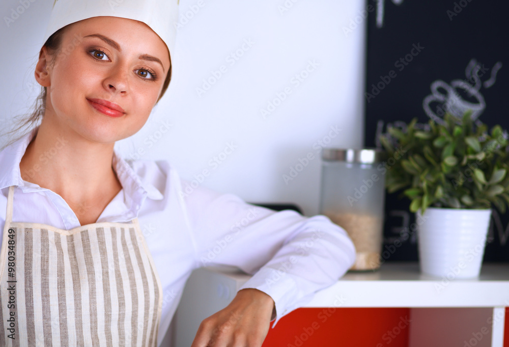 Chef woman portrait with uniform in the kitchen Chef woman portrait with uniform in the kitchen